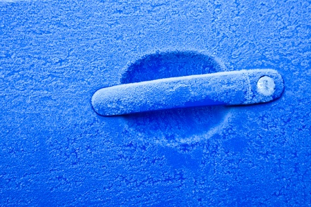 Ice on a blue car during winter season, good for conceptsの写真素材