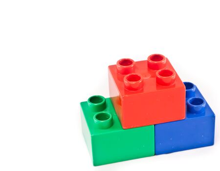 Plastic building blocks on white background. Bright colors.