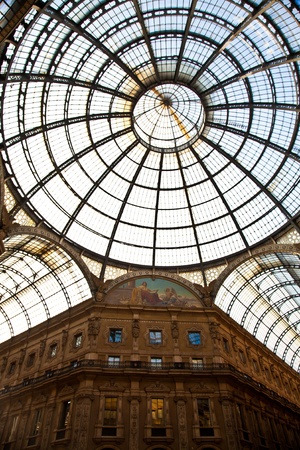 The Galleria Vittorio Emanuele II is a covered double arcade formed of two glass-vaulted arcades at right angles intersecting in an octagon, prominently sited on the northern side of the Piazza del Duomo in Milan.の写真素材