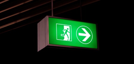 Emergency exit sign in modern offices inside an industrial plantの写真素材