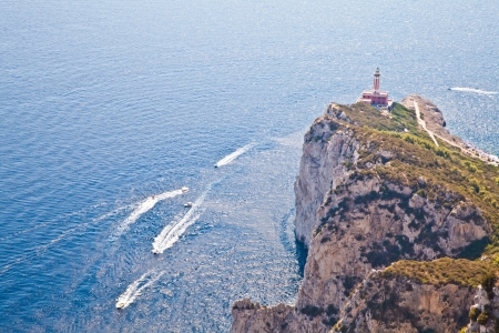 Panorama with Capri lighthouse and boats during a sunny dayの写真素材