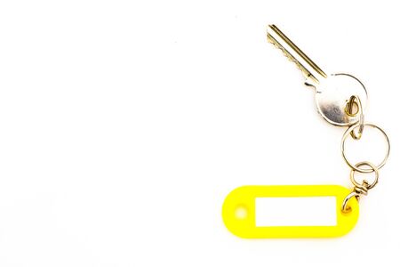 Key with a blank tag, isolate on white background. Add your text on the tag.の写真素材