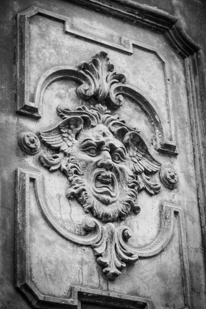 Gothic mask on an old wodden door in Milan - Italyの写真素材