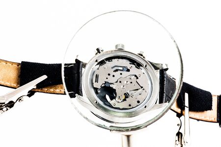 Elegant watch repaired using a magnifier with three handlesの写真素材