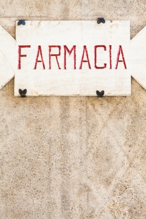 Penza, Tuscany region - Italy. An old pharmacy sign made of stoneの写真素材