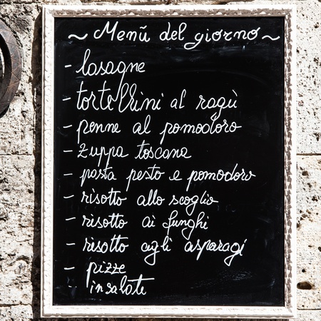Tuscany, Italy. A turistic menu exposed on a blackboard outside a restaurantの写真素材