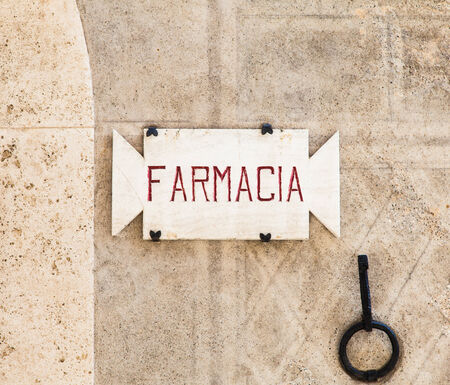 Penza, Tuscany region - Italy. An old pharmacy sign made of stoneの写真素材