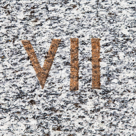 Roman numbers collection, from 1 to 7, on a real ancient graniteの写真素材