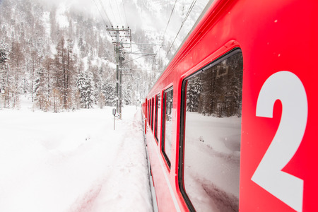A red train in the middle of a desert of snowの写真素材