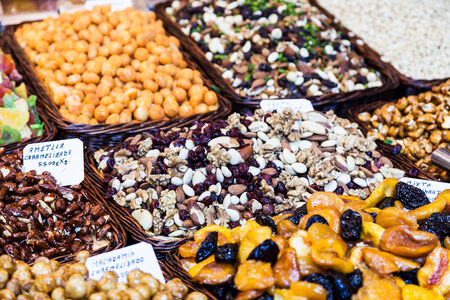 Interior of a busy food market, with detail on peanuts and almonds basketsの写真素材