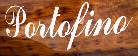 The name of the famous Portofino town in Italy on a boatside - landmark sign, no copyrightの写真素材