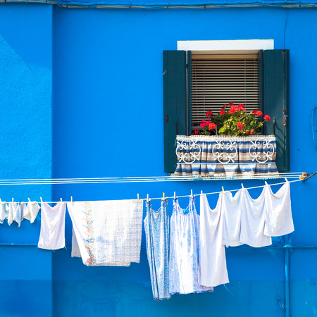 Burano Isle, close to Venice. Traditional colored houses during a sunny day.の写真素材