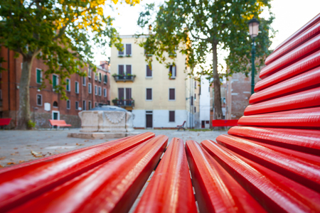 Unusual view of a traditional square in Venice from a benchの写真素材