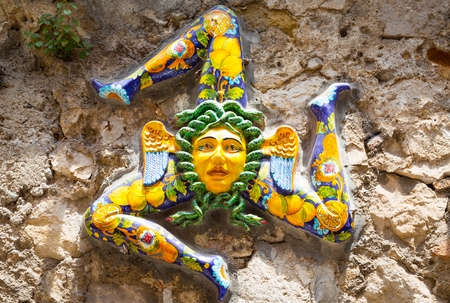 A typical ceramic Trinacria, the symbol of Sicily, hung along the streets of Taormina. Due to the islands distinct triangular shape, the symbol has also been adopted by the Sicilian government and is located on the center of Sicily's flag.の写真素材