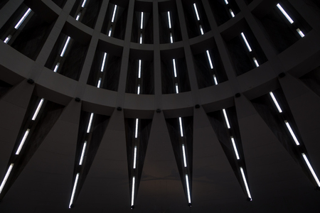 Detail of the ceiling of a modern building. Lines in prespective shaped by external sunlight. Useful background.の写真素材