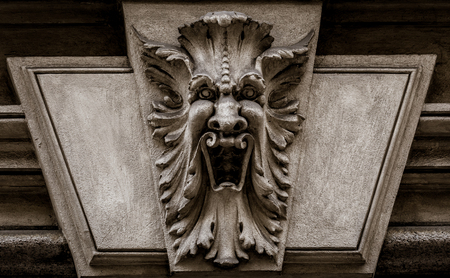 Italy, Turin. This city is famous to be a corner of two global magical triangles. This is a protective mask of stone on the top of a luxury palace entrance, dated around 1800のeditorial素材