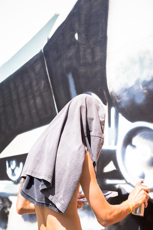 TURIN, ITALY - June 07, 2018: anonymous graffiti artist working on his piece of street art in urban areaのeditorial素材