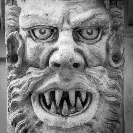Italy, Turin. This city is famous to be a corner of two global magical triangles. This is a protective mask of stone on the top of a luxury palace entrance, dated around 1800の写真素材