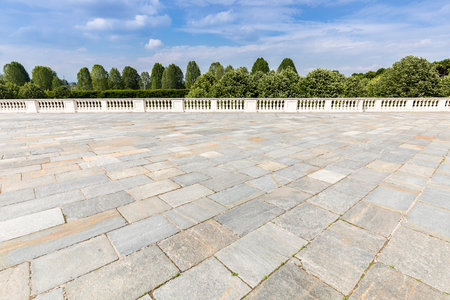 Exterior with old grey floor made of stone. Vintage textured pavement and blue sky in the background.の写真素材