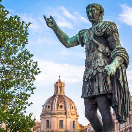 ITALY, ROME - CIRCA AUGUST 2020: Statue of Caesar Emperor, made of bronze. Natural sunrise light. Ancient  role model of Leadeship and Authority .のeditorial素材