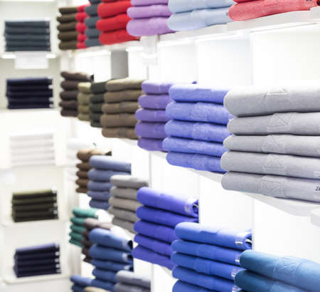 Polo t-shirt store interior. Shop shelves with  colored fashion cotton shirts.