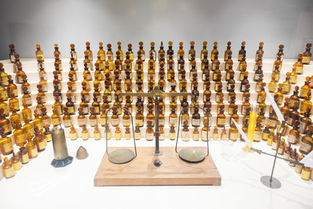 Grasse, France - August 2022: collection of ancient perfumes in laboratory with vintage balanceのeditorial素材