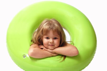 Young girl with green buoy on white backgroundの写真素材