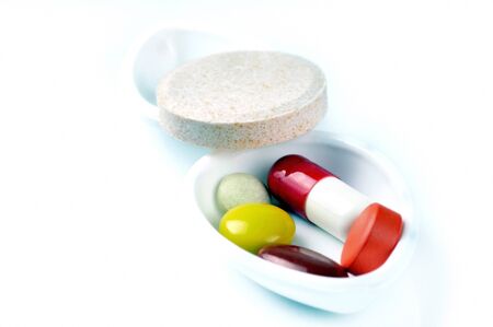Colored pills on white background