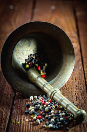 Pepper and mortar on the old woodの写真素材