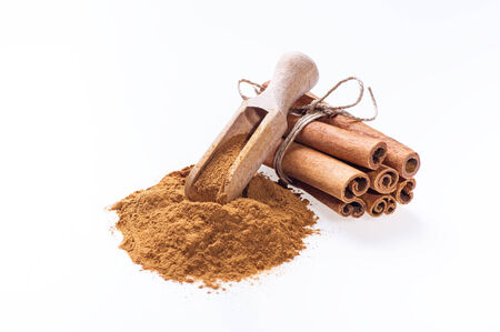 Cinnamon sticks and cinnamon powder on white の写真素材