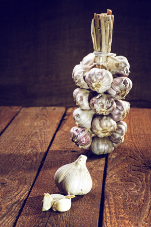 String of garlic on wooden backgroundの写真素材