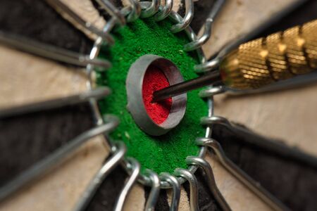 A dart hits the center of the darts board also known asの写真素材