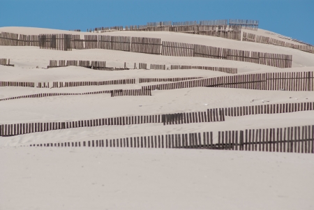Wooden fences on deserted beach dunes in Tarifa, Spainの写真素材