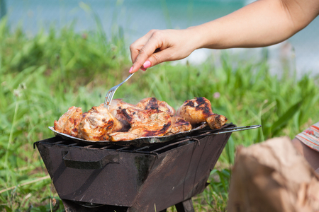 Grilled chicken thighs on the flaming grill の写真素材