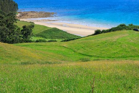 beach of San Vicente de la Barquera village an d Oyambre Cape in Cantabria Spainの写真素材