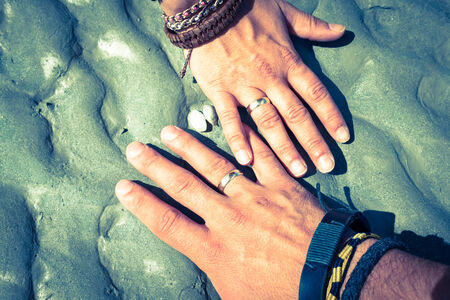 Couple holding hands together with their rings showingの写真素材