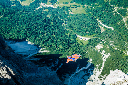 BASE jumper jumping off a big cliff in Dolomites,Italy, breathtakingの写真素材
