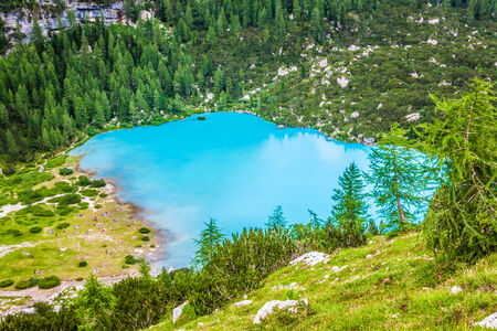 Turquoise Sorapis Lake  in Cortina d'Ampezzo, with Dolomite Mountains and Forest - Sorapis Circuit, Dolomites, Italy, Europeの写真素材