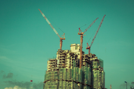 Building crane and building under constructionの写真素材