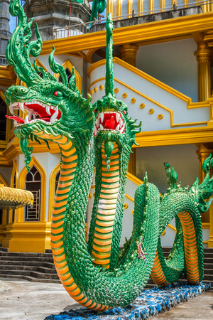 Green naka statue in front of Thai Buddhist pagoda at Tiger Cave Temple , Krabi , South of Thailand.の写真素材