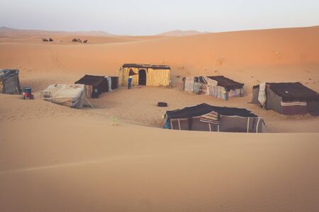 Tent camp for tourists in sand dunes of Erg Chebbi at dawn, Moroccoの写真素材