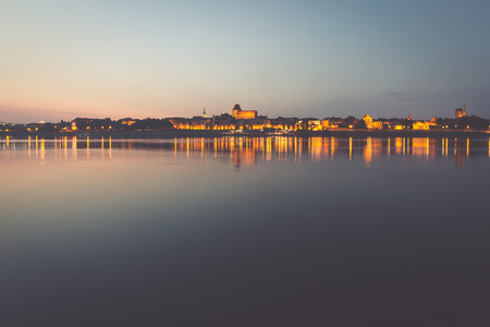City of Torun in Poland, old town skyline by night from Vistula riverの写真素材