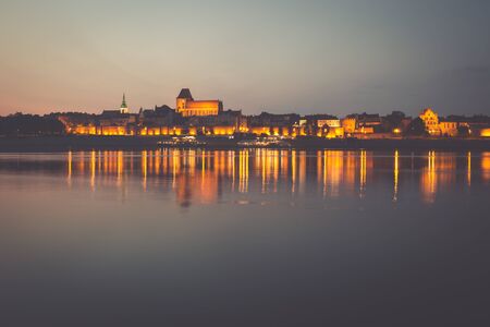 City of Torun in Poland, old town skyline by night from Vistula riverの写真素材