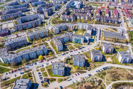 Aerial city view with crossroads and roads, houses, buildings, parks and parking lots.の写真素材