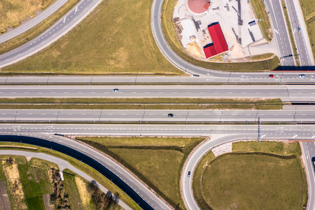 Aerial top view of the ring road, expressway looks like infinity sign with the moving carsの写真素材