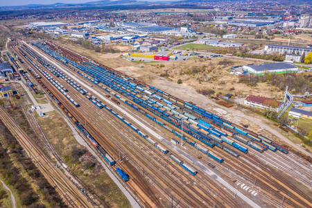 Cargo trains. Aerial view of colorful freight trains on the railway station. Wagons with goods on railroad.Aerial viewの写真素材