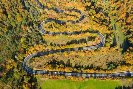 Drone view - Aerial view of autumn forest road. Top view of beautiful asphalt roadwayの写真素材