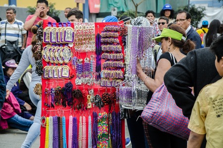 Lima, Peru - OCTOBER 28th 2017: Procession of the Lord of Miracles. Vendor of religious images in the processionのeditorial素材