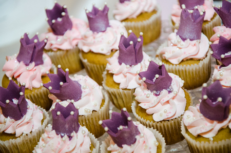 Cupcake with crown and cream of cakeの写真素材
