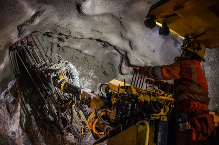 Mining machine arm drilling mineralsの写真素材